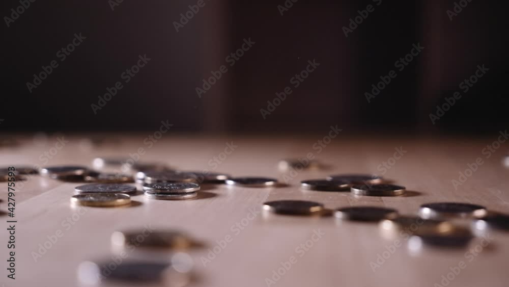 a coin falling on a wooden surface a coin falling on a wooden surface
