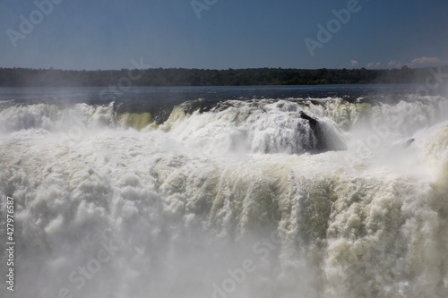 Fototapeta Naklejka Na Ścianę i Meble -  Nature's power. View of the Iguazu waterfalls and river, seen from Garganta del Diablo, in Misiones, Argentina. The amazing falls and falling white water beautiful texture, mist and splash.