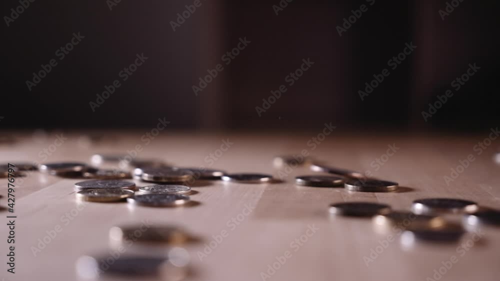 a coin falling on a wooden surface a coin falling on a wooden surface