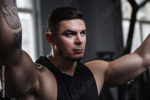 Close up of a handsome muscular male athlete looking focused in dramatic lighting