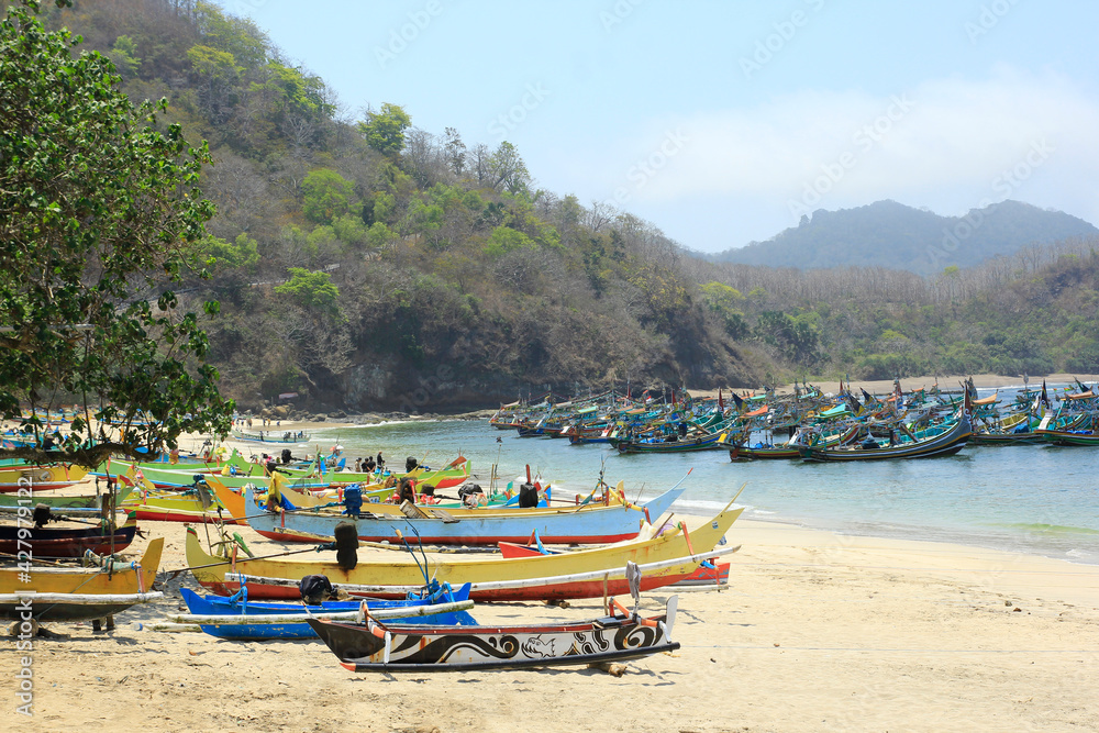 Jember, Indonesia, Sept 12, 2015. The view of the traditional fishermen's boats leaning on the beach of Tanjung Papuma is very beautiful and colorful.