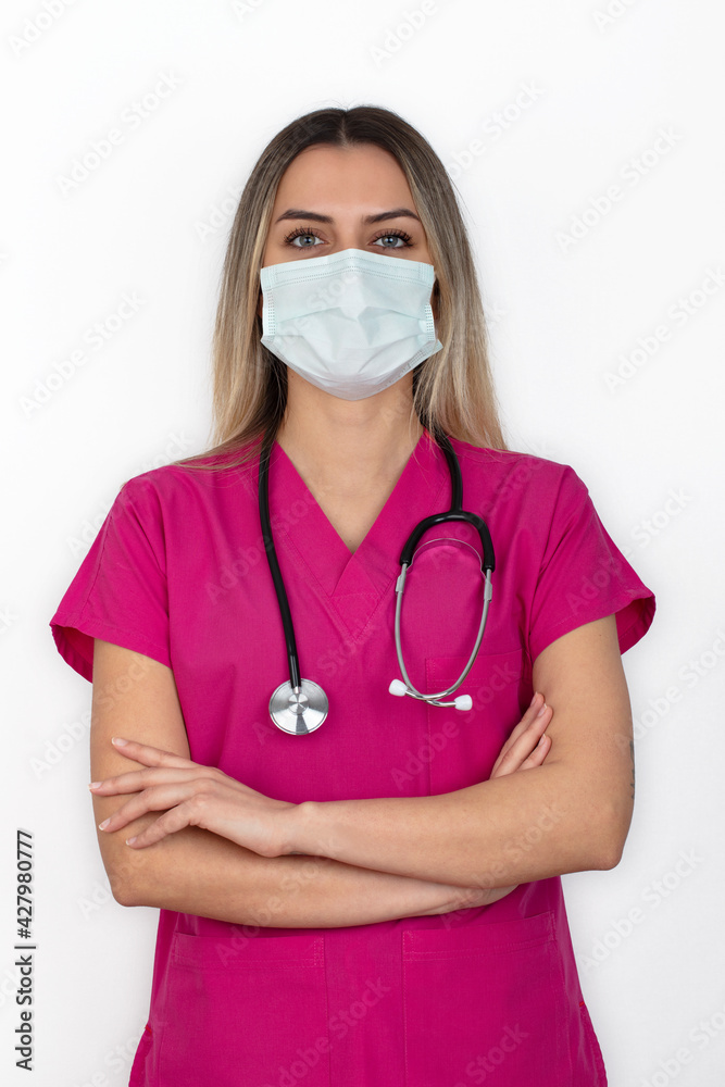 Nurse. Portrait on young woman nurse. medical student in her 20s wearing pink scrubs and stethoscope. Isolated on white background. Nurse. Portrait on young woman nurse. medical student in her 20s wearing pink scrubs and stethoscope. Isolated on white background.