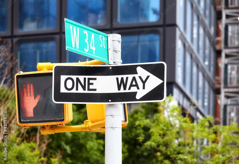 One way traffic sign on the West 34 Street in New York City, selective focus, USA. One way traffic sign on the West 34 Street in New York City, selective focus, USA.