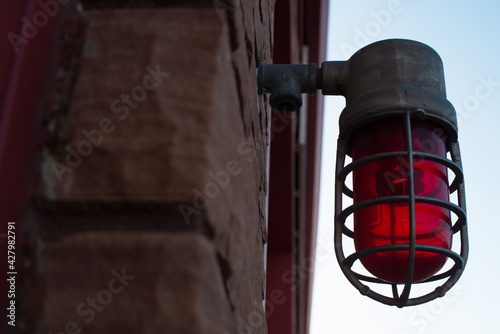 Old style vintage red light alert light on front of fire department station brick building zillah washington lower valley yakima county photo