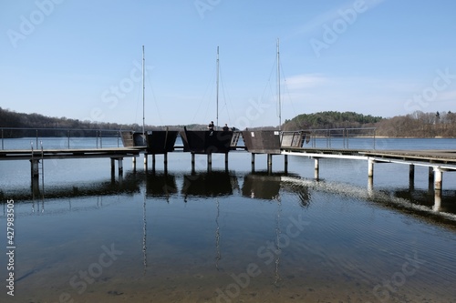 Wooden pier with elements looking like boats and bathing on Lake Struga, Kociewie, Poland © Iwona