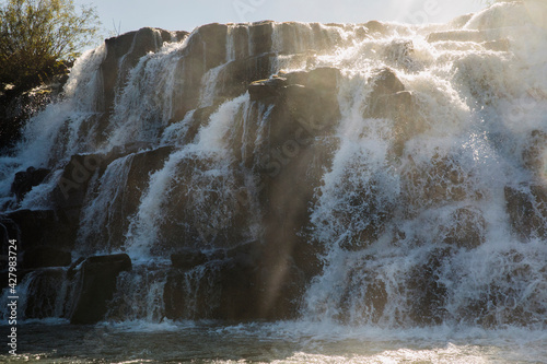 Poetic view of the The Mocona falls. The rocky waterfalls and falling white water with a beautiful sun ray.