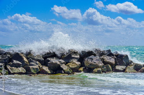 Wave breaking over a rock breakwater - Dania Beach, Florida, USA