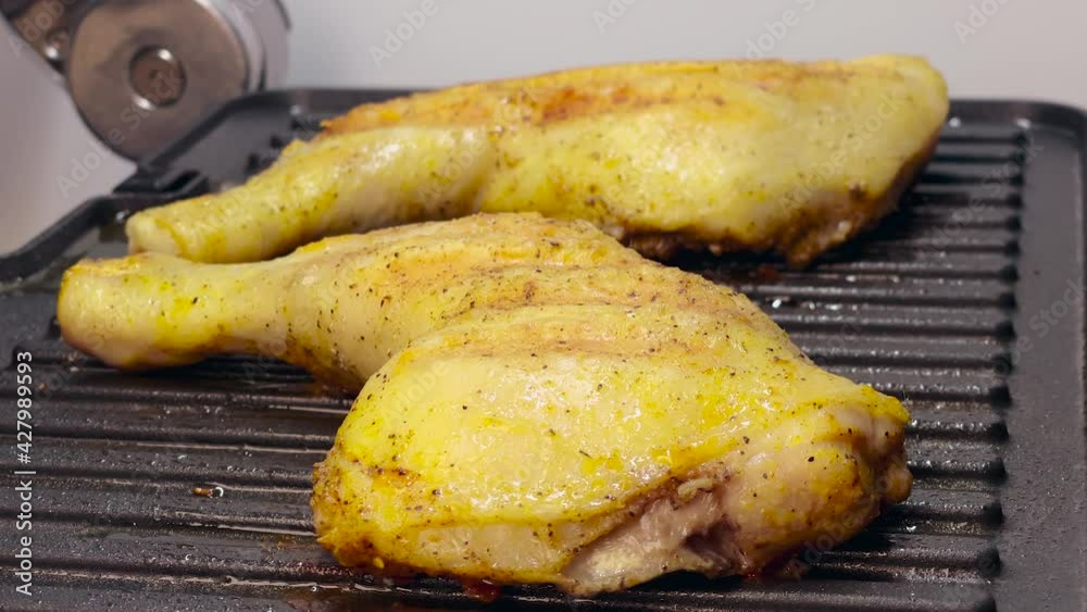 Homemade grilled chicken thighs. Preparing chicken meat on electric