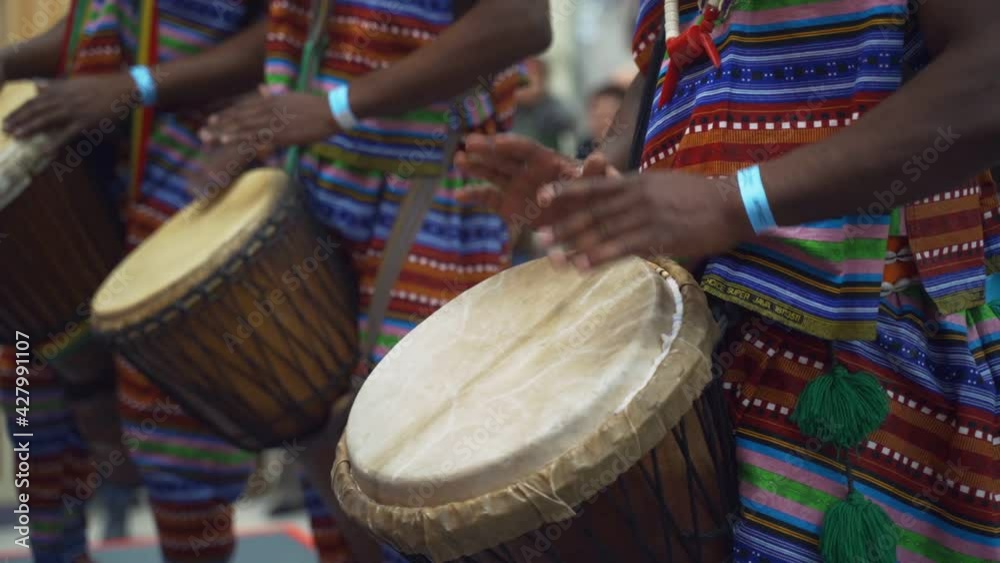 Man playing drum by his hands. Street performance using percussion instruments in slow motion
