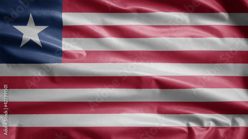 Liberian flag waving in the wind. Close up of Liberia banner blowing soft silk.