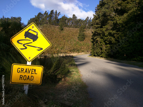 a road up the mountain in new zealand with a danger sign