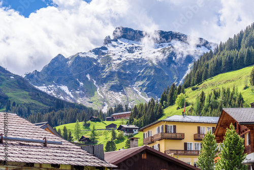 Beautiful Swiss mountain valley landscape with a house roof.