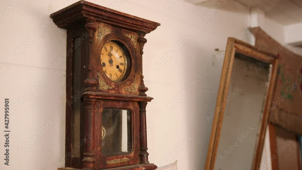 Broken antique mechanical wall clock that once showed the hour in room. Time
