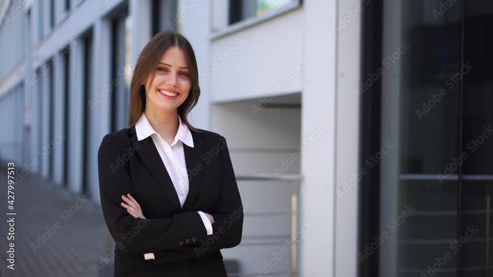 A beautiful woman in a business suit crosses her arms and looks away A beautiful woman in a business suit crosses her arms and looks away