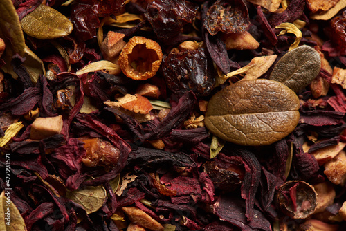 Tea leaves with hibiscus as a background.