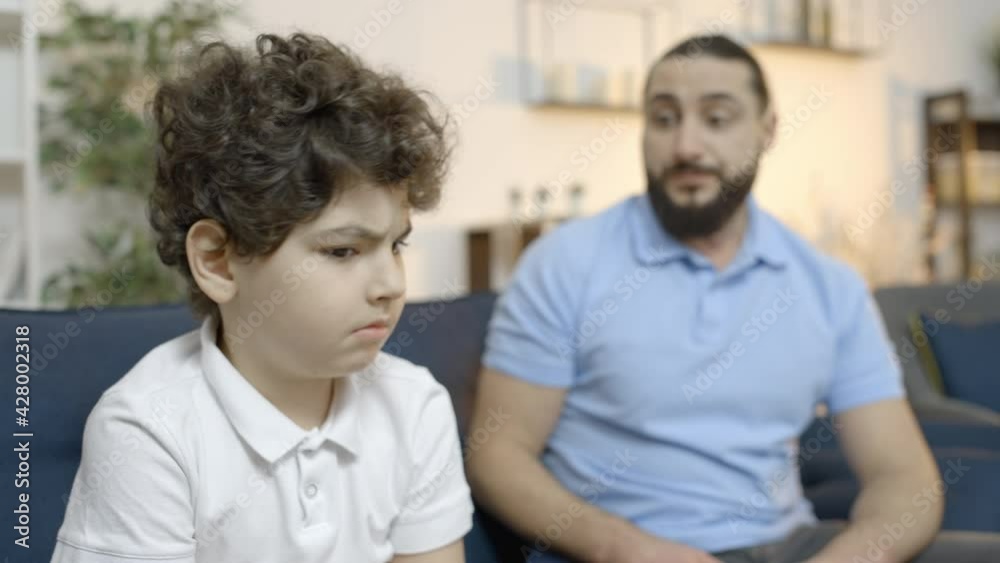 Strict father scolding son, criticizing sad little boy for mistake, parenting Strict father scolding son, criticizing sad little boy for mistake, parenting
