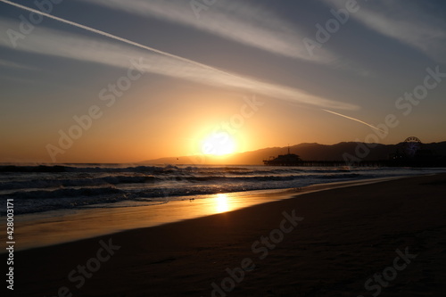 Sunset at Santa Monica Beach  California. The golden color of the sand.