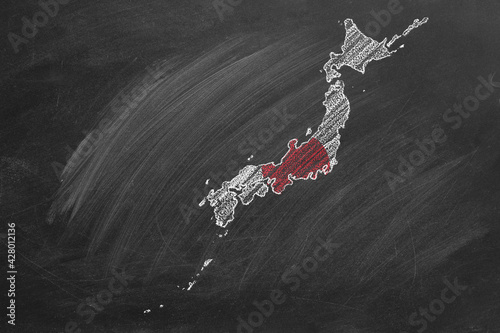 Country map and flag of Japan drawing with chalk on a blackboard. One of a large series of maps and flags of different countries. Education, travel, study abroad concept.