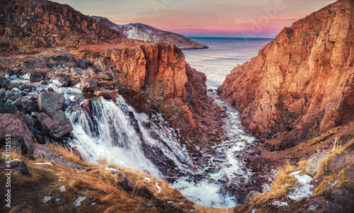 Picturesque waterfall of the Small Battery Lake on the Kola Peninsula, Teriberka. © sablinstanislav
