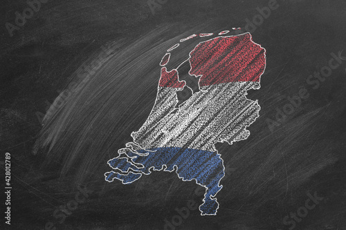 Country map and flag of The Netherlands drawing with chalk on blackboard. Hand drawn animation. One of a large series of maps and flags of different countries. Education, travel, study abroad concept
