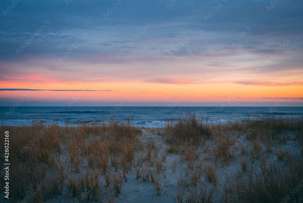 Sand dunes and the Atlantic Ocean at sunset, at Smith Point, Fire Island, New York