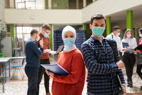 Portrait of multiethnic students group at university wearing protective face mask