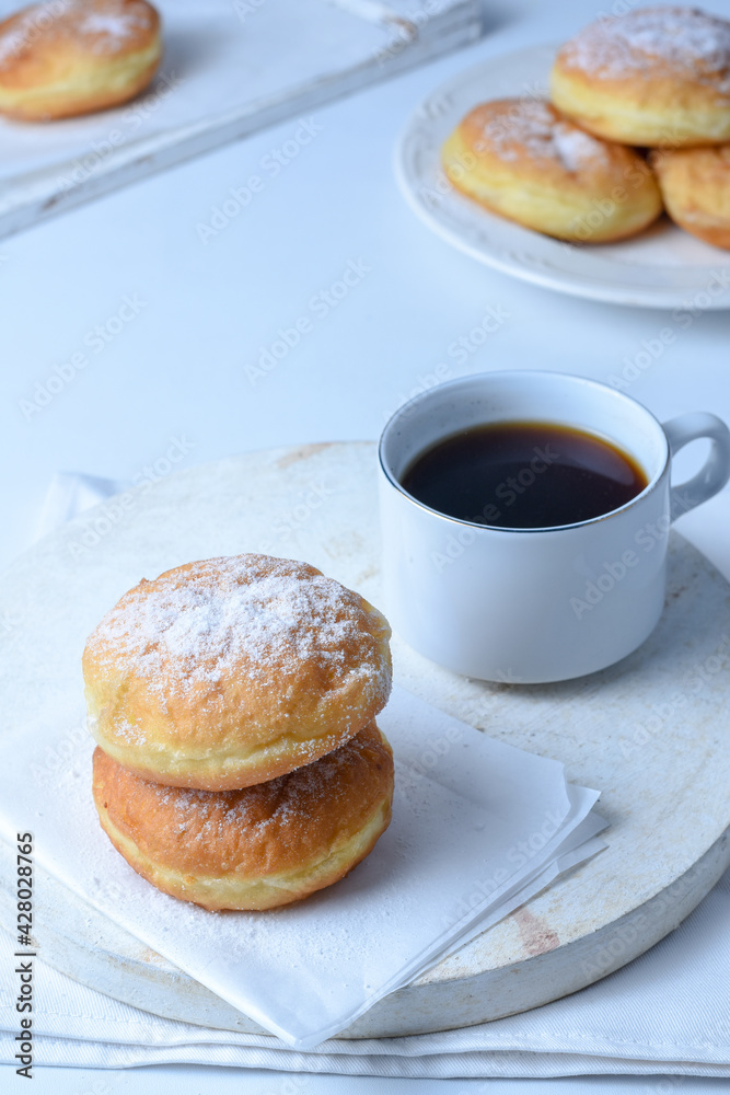 sweet bombolone or Krapfen (or berliner, or doughnut ) made from yeast dough fried, with chocolate curd filling, powdered conventional sugar on top. sweet bombolone or Krapfen (or berliner, or doughnut ) made from yeast dough fried, with chocolate curd filling, powdered conventional sugar on top.