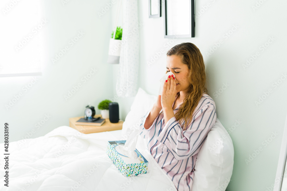 Hispanic woman in bed feeling bad and sick Hispanic woman in bed feeling bad and sick