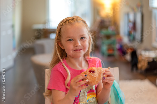 Cute little girl eating a donut