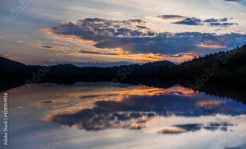 Fototapeta Naklejka Na Ścianę i Meble -  Beautiful reflection of a bright sunset in the lake