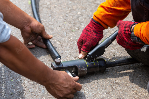 Close-up of electricians' equipment To clamp the metal to connect the largely broken wires Using a metal pipe, electrical insulation is plugged into the broken wire using a large clamp.