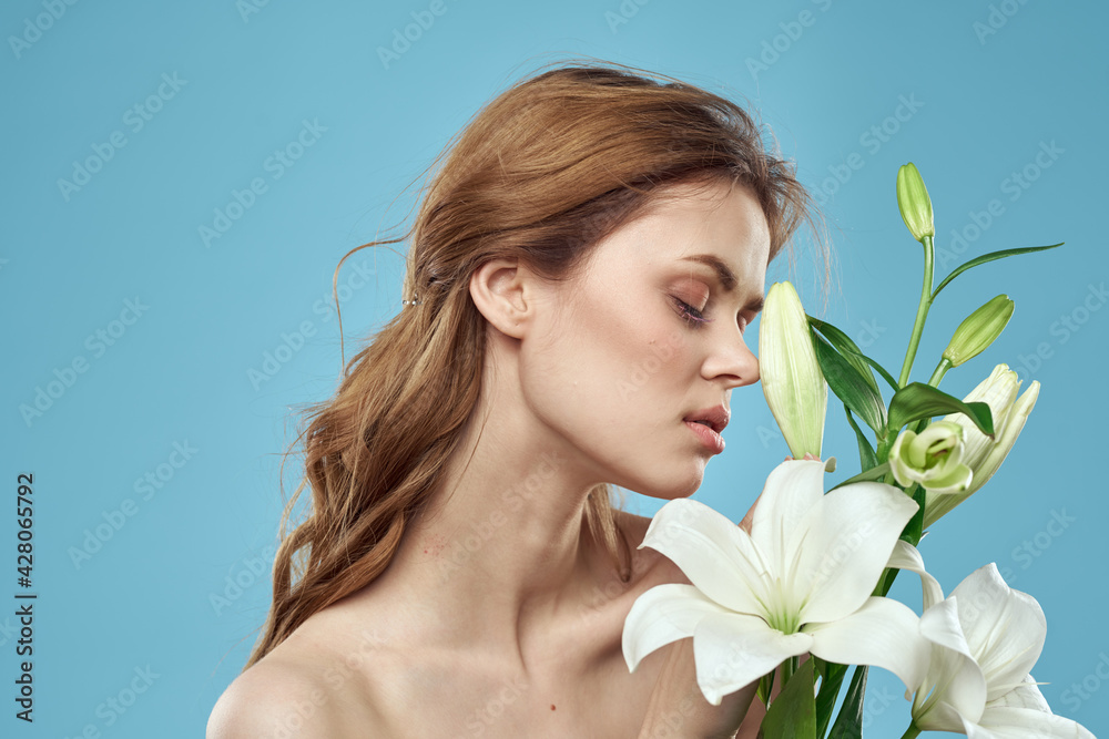Girl with a bouquet of white flowers on a blue background red hair portrait model Girl with a bouquet of white flowers on a blue background red hair portrait model