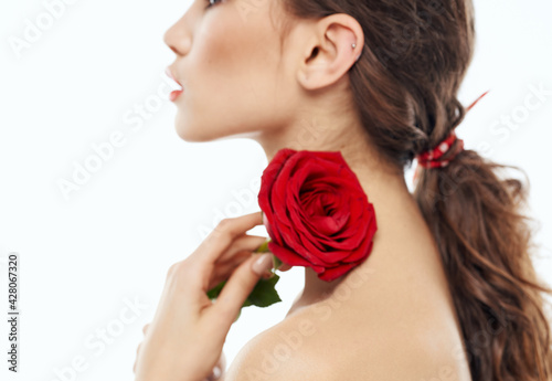 Woman with flower cropped view makeup red lips model rose