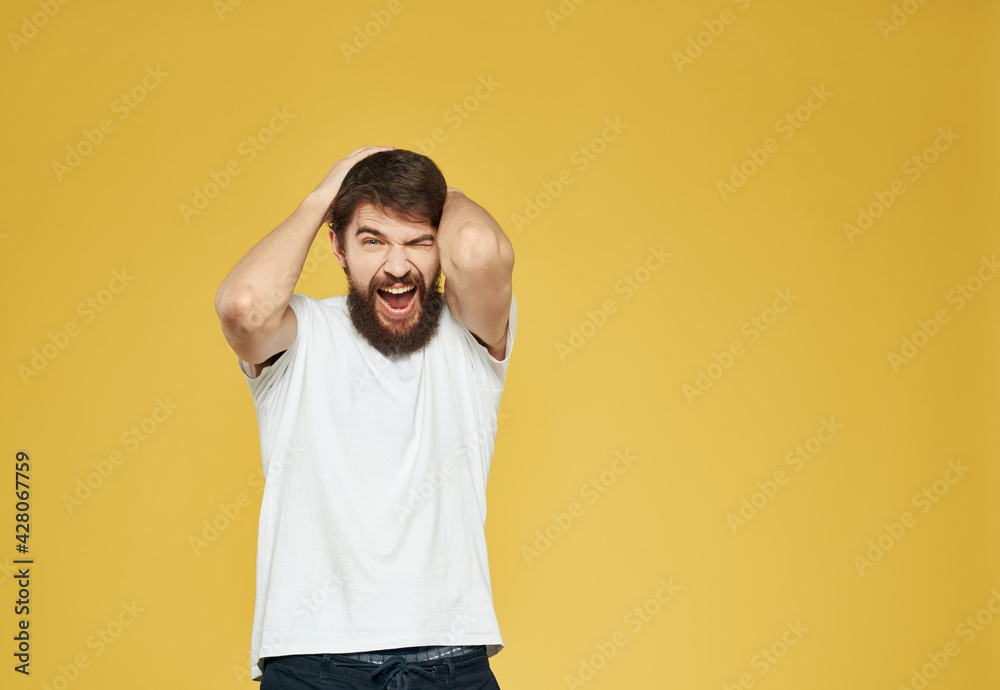 male model gesturing with his hands on a yellow background cropped view Copy Spac male model gesturing with his hands on a yellow background cropped view Copy Spac