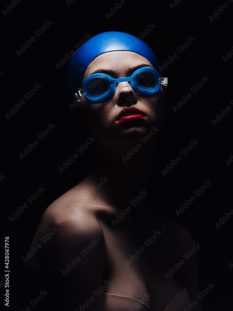 beautiful woman in goggles for swimming and bright makeup red lips black background beautiful woman in goggles for swimming and bright makeup red lips black background