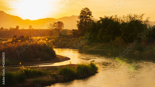 Quadro su tela Scenery of the Moei River during sunset It is a natural border between Thailand and Burma in Mae Sot District