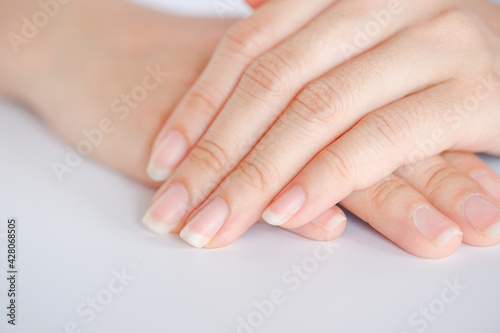 Obraz na plátne Closeup of beautiful hands and fingernails of woman on white background, Concept of health care of the fingernail