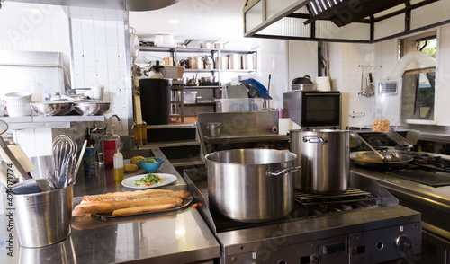 View of worktops and kitchen equipment in empty professional restaurant kitchen..