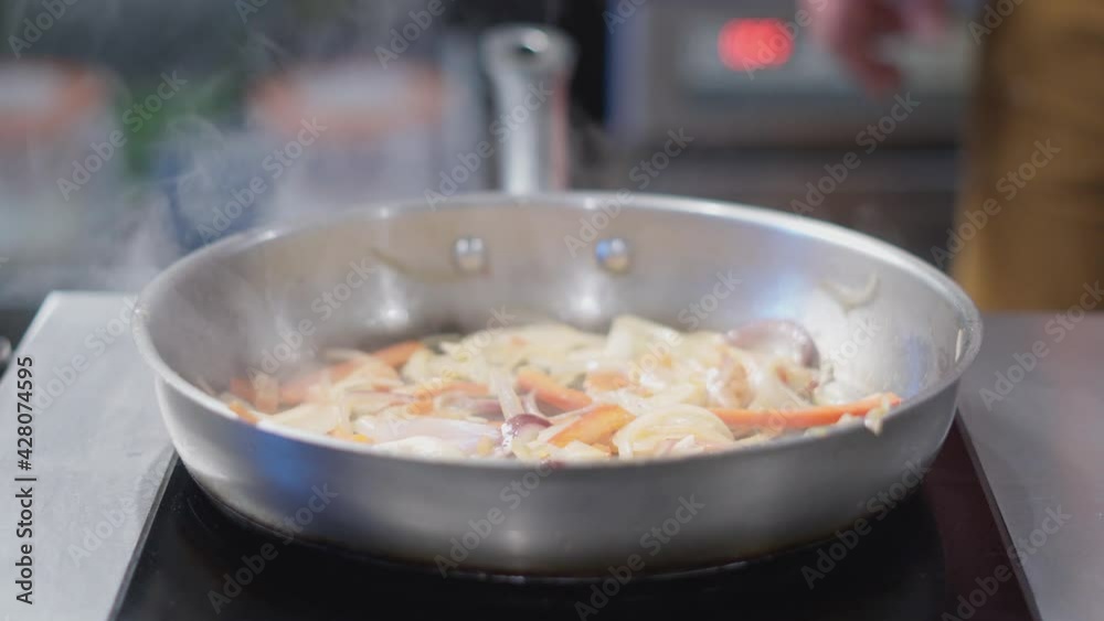 Tomatoes, peppers and onion are fried onto a pan. Tomatoes, peppers and onion are fried onto a pan.