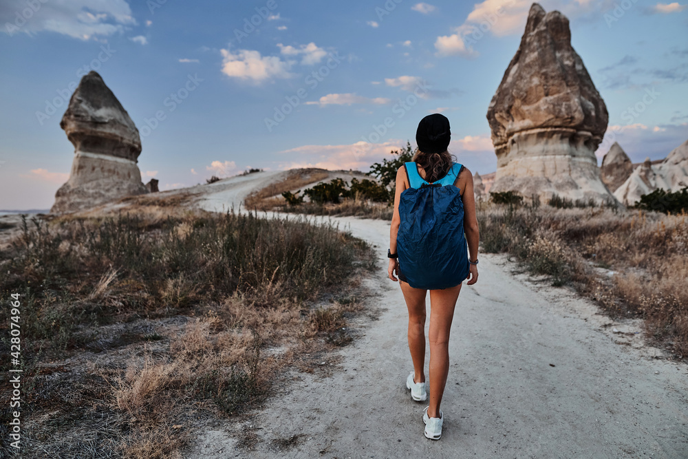 Beautiful tourist woman walking in Love valley in Goreme village