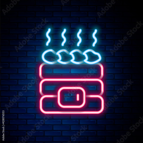 Glowing neon line Hot sauna stones icon isolated on brick wall background. Spa resort recreation, bathhouse relaxation. Hot stones on electric heater. Colorful outline concept. Vector
