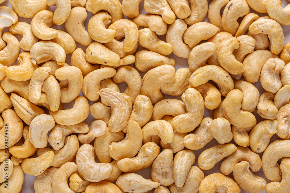 Pile of peeled cashew as texture background. Healthy vegetarian snacks. Protein-containing foo Pile of peeled cashew as texture background. Healthy vegetarian snacks. Protein-containing foo