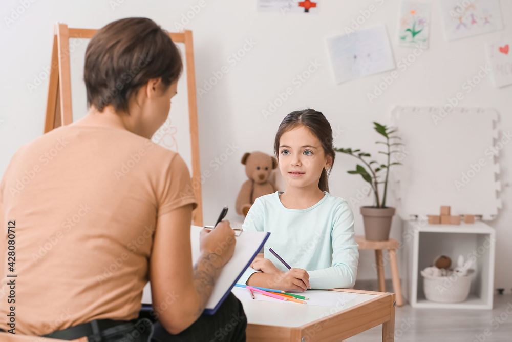 Fototapeta premium Female psychologist working with little girl at home