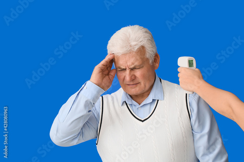 Measuring of sick senior ma...