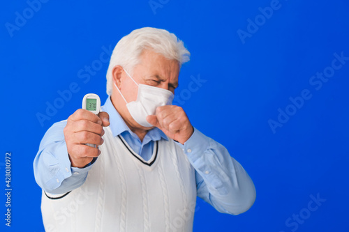 Senior man measuring his te...