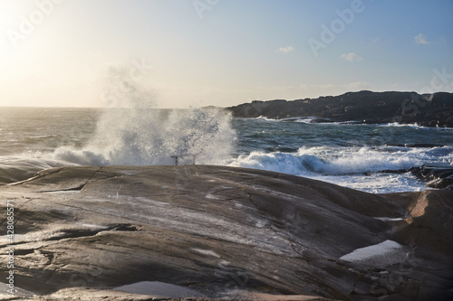 Fototapeta Naklejka Na Ścianę i Meble -  A big wave is comming in from the sea during a storm splashing over land