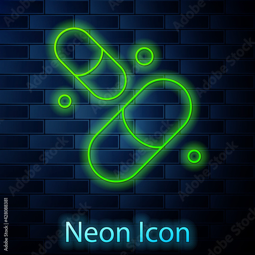 Glowing neon line Vitamin complex of pill capsule icon isolated on brick wall background. Healthy lifestyle. Vector