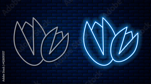 Glowing neon line Pistachio nuts icon isolated on brick wall background. Vector