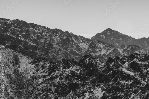 Layers of mountain ridges in black and white, Tatra National Park, Poland. The view to Slovak side of High Tatras. Selective focus on the rocks, blurred background.