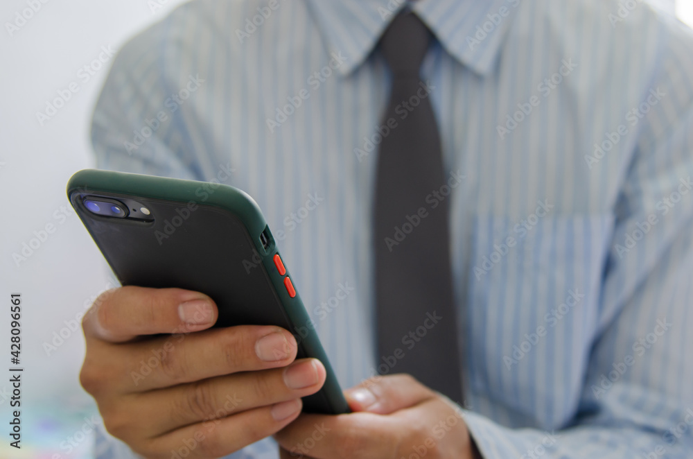 Close up hand holding businessman using mobile smart phone communicate online browse internet. Close up hand holding businessman using mobile smart phone communicate online browse internet.